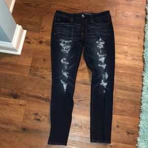 A dark blue American Eagle ripped jegging jean
